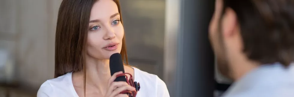 Journalism-test-pretty-young-journalist-interviewing-a-famous-person-in-a-st