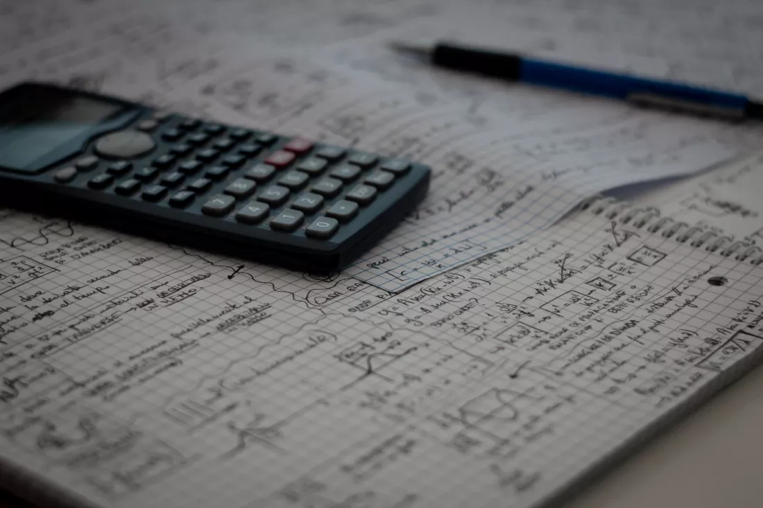 high-angle-view-book-with-calculator-pen-table