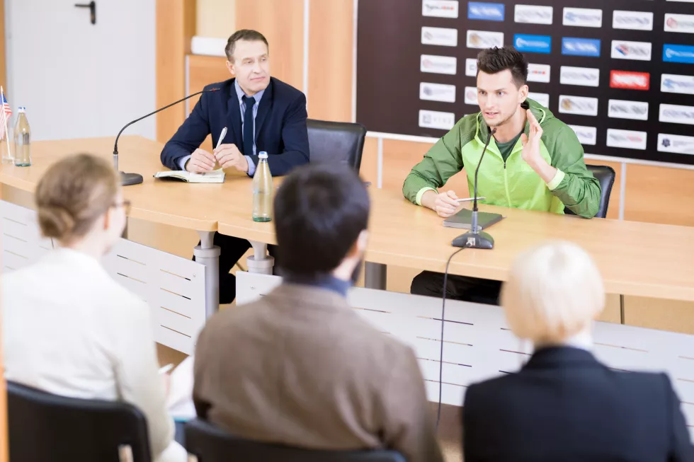 young-sportsman-coach-press-conference